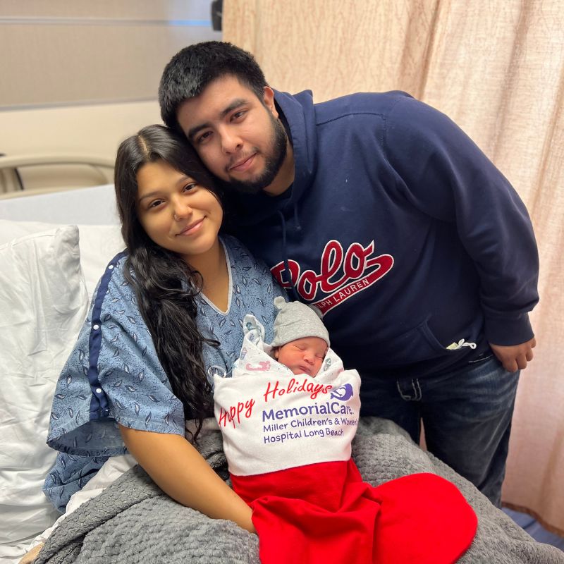 A picture-perfect moment for mom, Arlette Morfin, who was a baby in a stocking 19 years ago, and father Freddy Montes cuddling their holiday baby Xavier Morfin-Montes at Miller Children’s & Women’s.